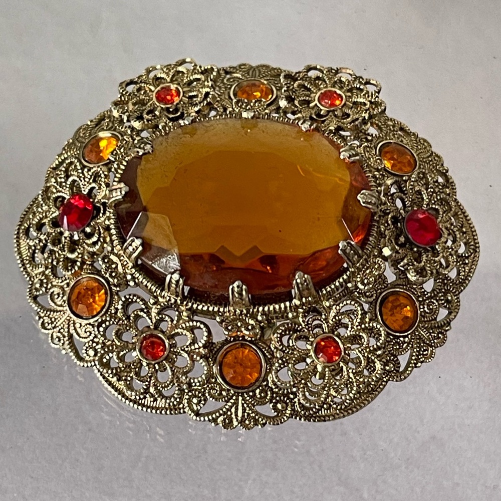 Vintage West Germany brooch featuring a large amber topaz glass filigree gold